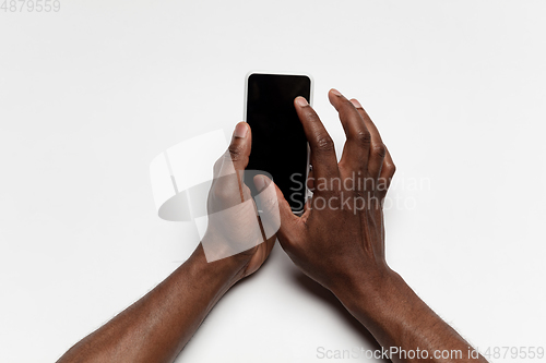 Image of Close up of human hand using smartphone with blank black screen, education and business concept