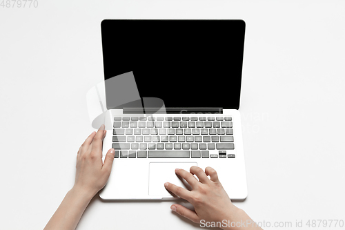 Image of Close up of human hand using laptop with blank black screen, education and business concept