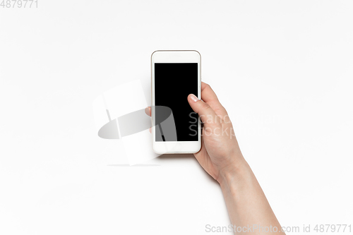Image of Close up of human hand using smartphone with blank black screen, education and business concept