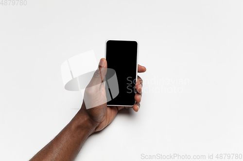 Image of Close up of human hand using smartphone with blank black screen, education and business concept