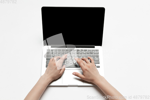 Image of Close up of human hand using laptop with blank black screen, education and business concept