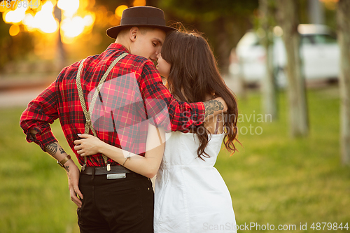 Image of Caucasian young and happy couple enjoying a picnic in the park on summer day