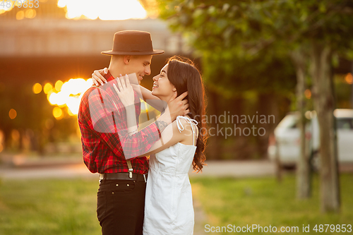 Image of Caucasian young and happy couple enjoying a picnic in the park on summer day