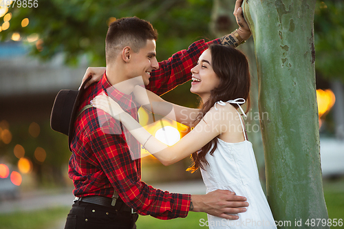 Image of Caucasian young and happy couple enjoying a picnic in the park on summer day