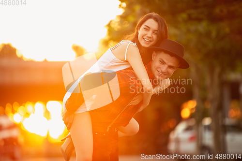 Image of Caucasian young and happy couple enjoying a picnic in the park on summer day