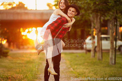 Image of Caucasian young and happy couple enjoying a picnic in the park on summer day