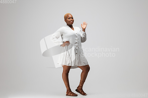 Image of Young african-american woman in casual wear on gray background. Bodypositive female character, plus size businesswoman