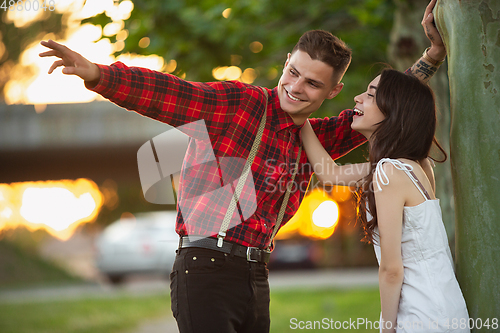 Image of Caucasian young and happy couple enjoying a picnic in the park on summer day