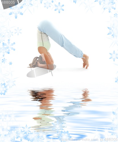 Image of salamba sirsasana supported headstand on white sand