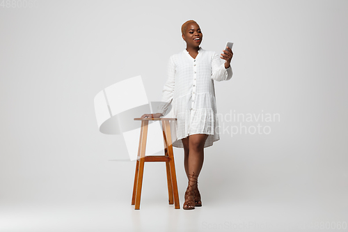 Image of Young african-american woman in casual wear on gray background. Bodypositive female character, plus size businesswoman