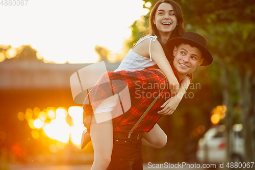 Image of Caucasian young and happy couple enjoying a picnic in the park on summer day