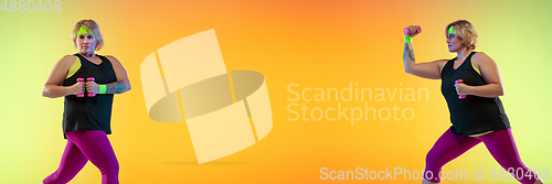 Image of Young caucasian plus size female model\'s training on gradient orange background
