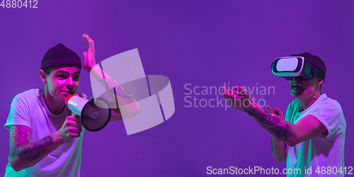 Image of Caucasian man\'s portrait isolated on purple studio background in neon light