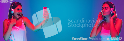 Image of Caucasian young woman\'s portrait isolated on blue background in neon light