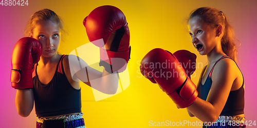 Image of Little caucasian female kick boxer training on gradient background in neon light, active and expressive