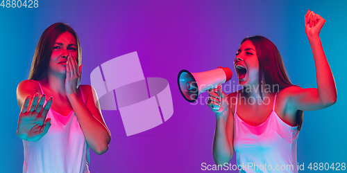 Image of Caucasian young woman\'s portrait isolated on blue background in neon light