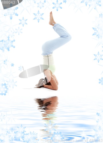 Image of salamba sirsasana supported headstand on white sand