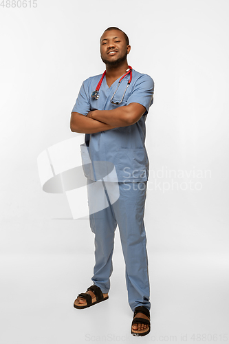 Image of Beautiful african-american doctor smiling isolated over white studio background