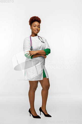 Image of Beautiful african-american doctor or nurse smiling isolated over white studio background