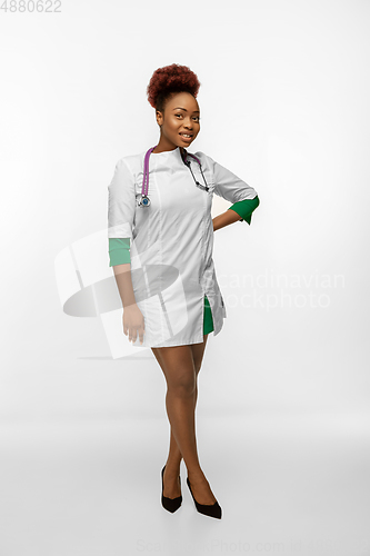 Image of Beautiful african-american doctor or nurse smiling isolated over white studio background