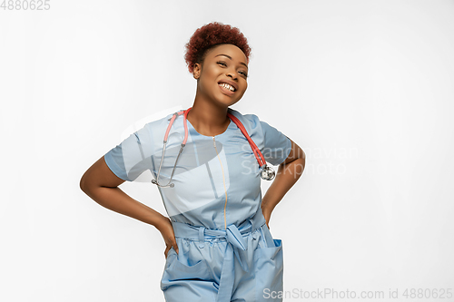 Image of Beautiful african-american doctor or nurse smiling isolated over white studio background