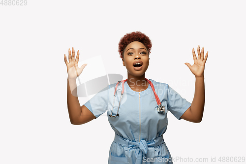 Image of Beautiful african-american doctor or nurse smiling isolated over white studio background