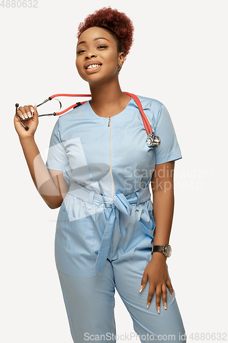 Image of Beautiful african-american doctor or nurse smiling isolated over white studio background