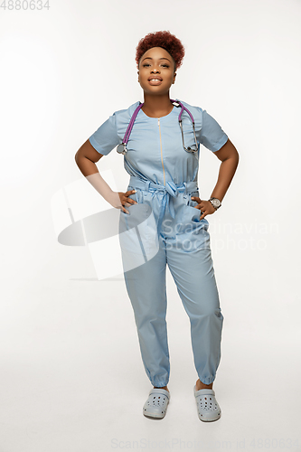 Image of Beautiful african-american doctor or nurse smiling isolated over white studio background