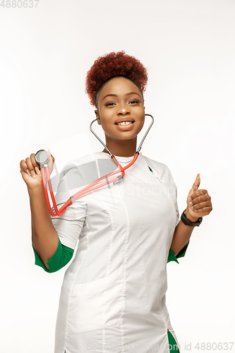 Image of Beautiful african-american doctor or nurse smiling isolated over white studio background