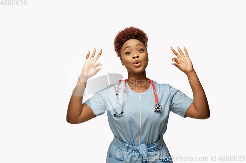 Image of Beautiful african-american doctor or nurse smiling isolated over white studio background
