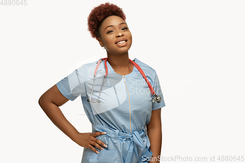 Image of Beautiful african-american doctor or nurse smiling isolated over white studio background