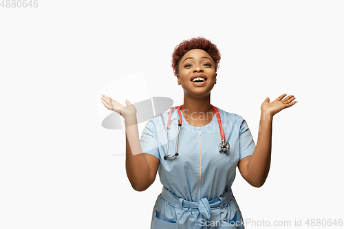 Image of Beautiful african-american doctor or nurse smiling isolated over white studio background