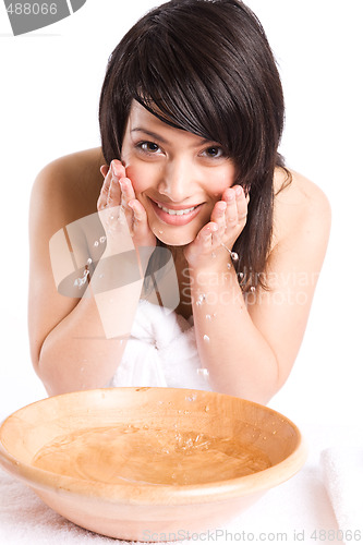 Image of Beautiful asian girl washing face