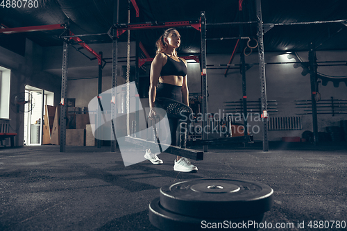 Image of Beautiful young sporty woman training, workout in gym