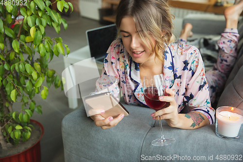 Image of Portrait of pretty young girl in modern apartment in the morning. Resting, calm, salisfied. Youth and wellness concept.