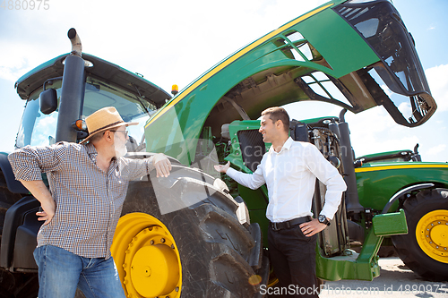 Image of A farmer with a tractor, combine at a field in sunlight. Confident, bright colors