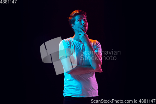 Image of Caucasian beautiful young man\'s portrait on black studio background, emotional and expressive. Copyspace for ad.