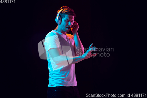 Image of Caucasian beautiful young man\'s portrait on black studio background, emotional and expressive. Copyspace for ad.