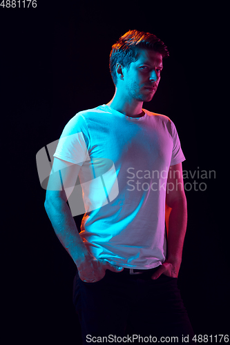 Image of Caucasian beautiful young man\'s portrait on black studio background, emotional and expressive. Copyspace for ad.