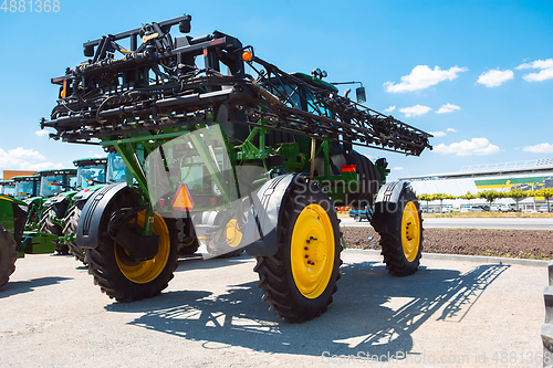 Image of Tractor, combine at a field in sunlight. Confident, bright colors