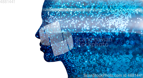 Image of silhouette of woman face on blue glitters