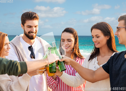 Image of friends toasting non alcoholic drinks on beach