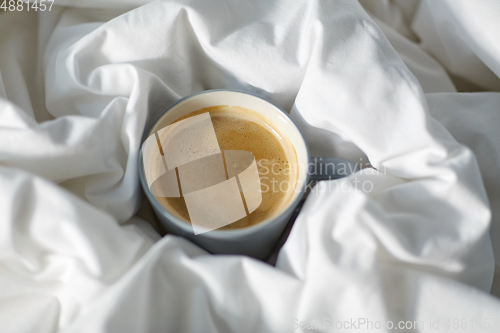 Image of cup of coffee in bed