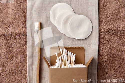 Image of wooden toothbrush, cotton pads and swabs in box