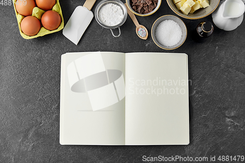 Image of recipe book and cooking ingredients on table