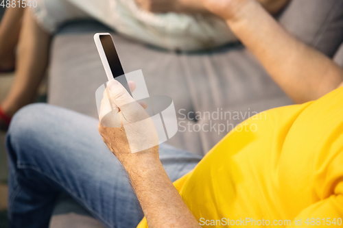 Image of Couple of seniors spending time together being quarantined - caucasians mature and retired man and woman using modern gadgets, talking, drinking tea