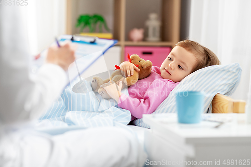 Image of doctor with clipboard and sick girl in bed at home