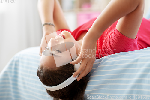 Image of girl in headphones listening to music at home