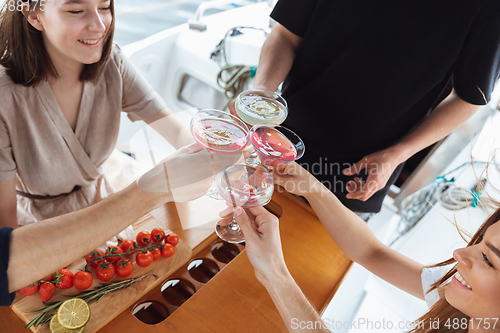 Image of Top view group of happy friends drinking vodka cocktails at boat party outdoor, cheerful and happy