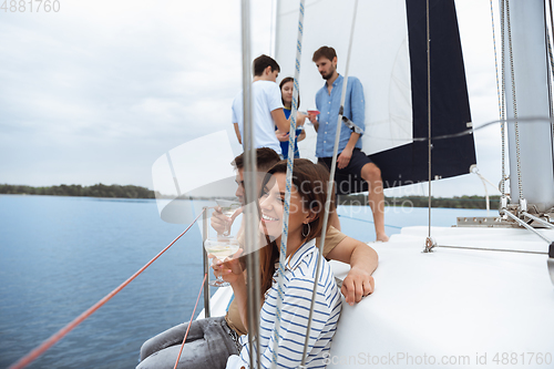 Image of Group of happy friends drinking vodka cocktails at boat party outdoor, cheerful and happy